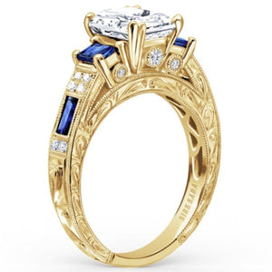 Kirk Kara Yellow Gold "Charlotte" Blue Sapphire Diamond Three Stone Engagement Ring Angled Side View 