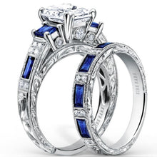 Load image into Gallery viewer, Kirk Kara White Gold &quot;Charlotte&quot; Blue Sapphire Diamond Three Stone Engagement Ring Set Angled Side View 
