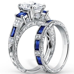 Kirk Kara White Gold "Charlotte" Blue Sapphire Diamond Three Stone Engagement Ring Set Angled Side View 
