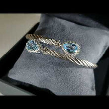 Load and play video in Gallery viewer, Gabriel &amp; Co. Steel and Sterling Silver Blue Topaz Cable Bangle

