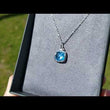 Load and play video in Gallery viewer, Gabriel &amp; Co. Sterling Silver Cushion Shaped Blue Topaz Pendant
