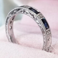 Load image into Gallery viewer, Kirk Kara White Gold &quot;Charlotte&quot; Blue Sapphire Baguette Cut Diamond Wedding Band Angled Side View in Box
