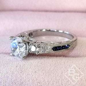 Kirk Kara White Gold "Charlotte" Three Stone Blue Sapphire Diamond Engagement Ring Angled Side View on Box