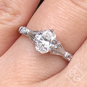 Kirk Kara White Gold "Lori" Oval Cut Diamond Engagement Ring Close Up on Model Hand