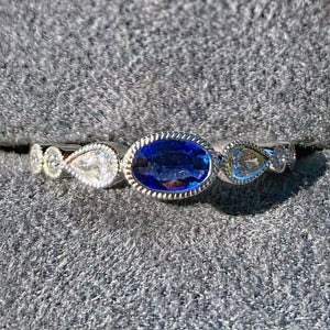 Simon G. Oval Cut Bezel Set Blue Sapphire and Diamond Ring Front View In Box