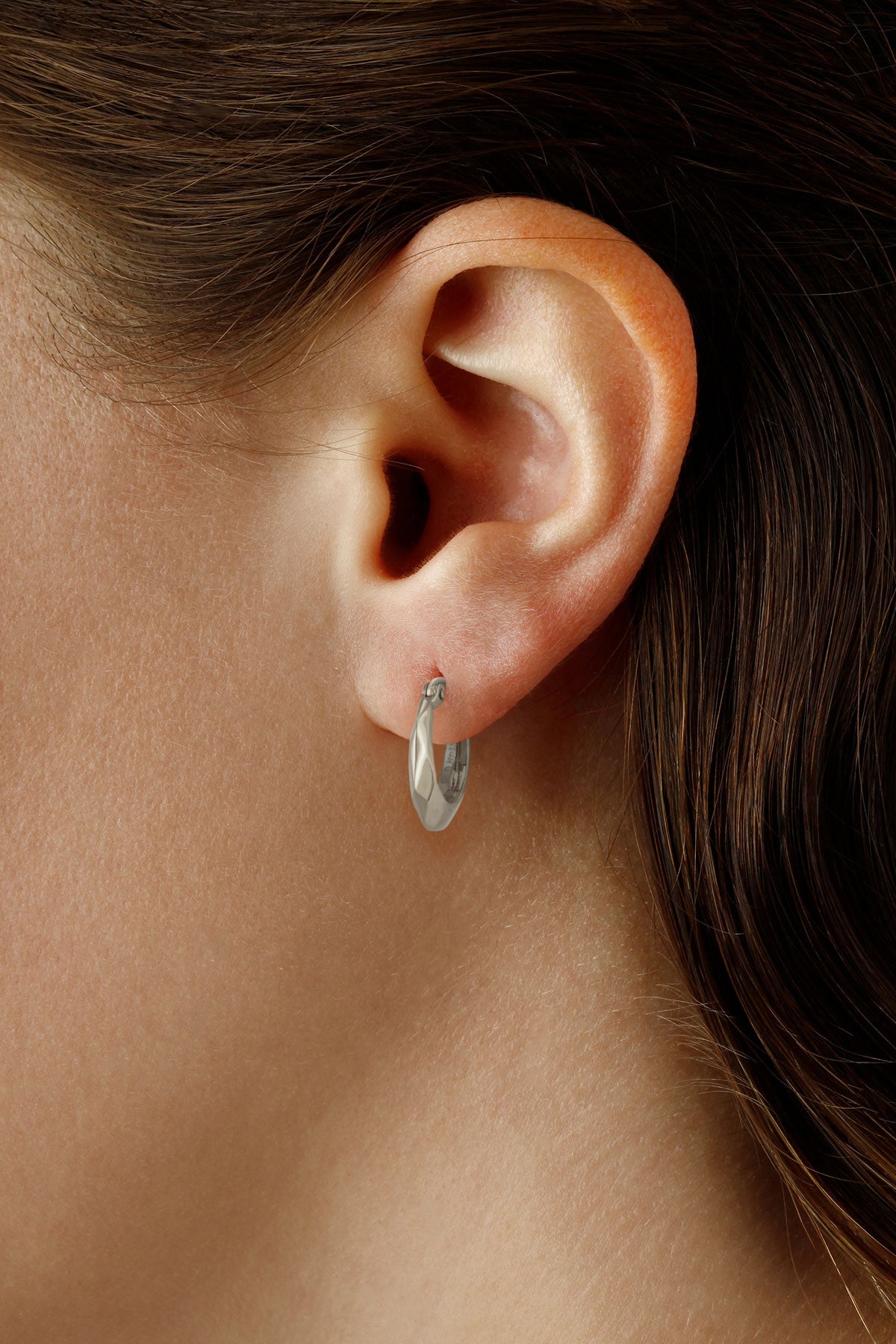 Ben Garelick 14K white gold faceted small hoop earring worn close to the earlobe