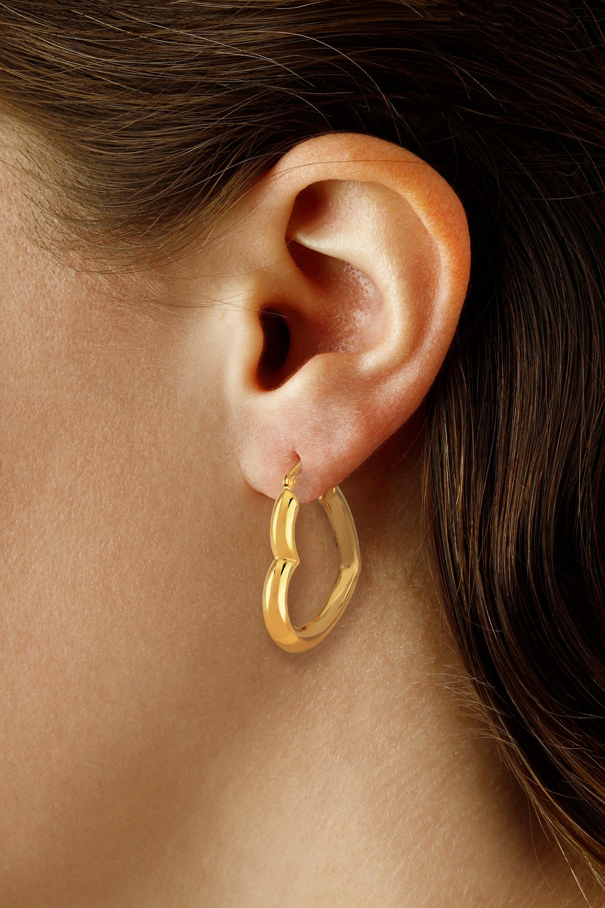 Ben Garelick 14K yellow gold heart hoop earring shown on the ear