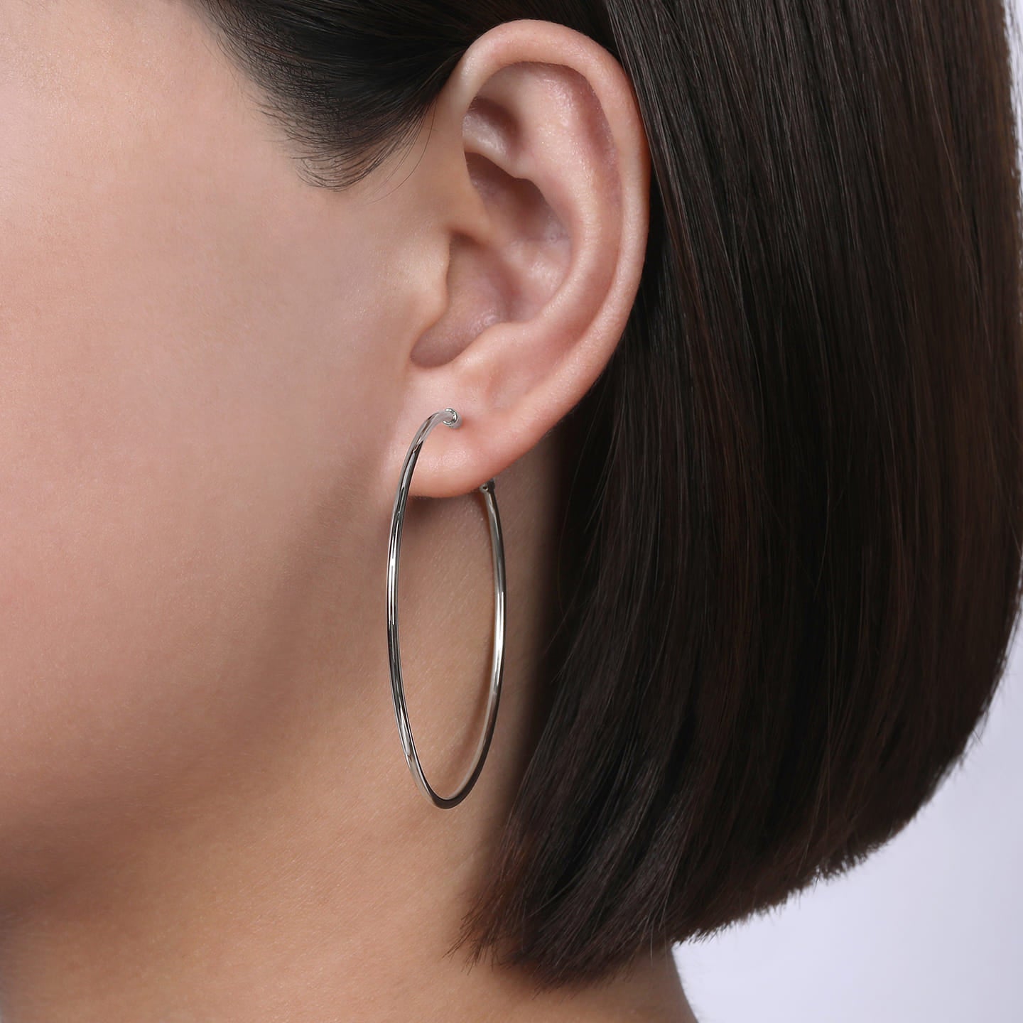 Gabriel & Co. 50MM White Gold High Polished Round Classic Hoop Earrings on Model's Ear