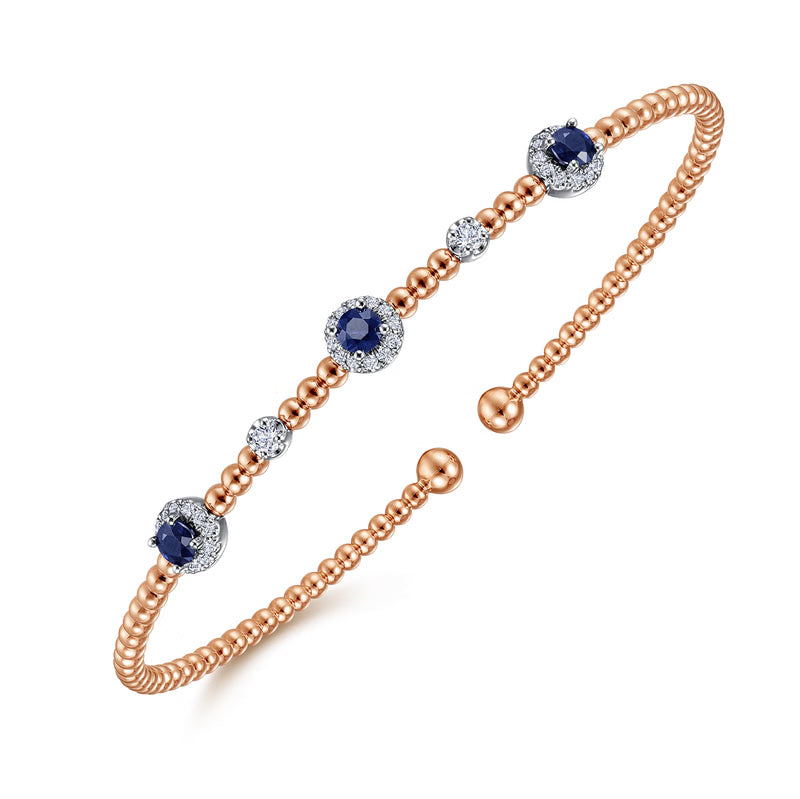 Angled view of the white and rose gold Bujukan sapphire bangle showing the beaded band