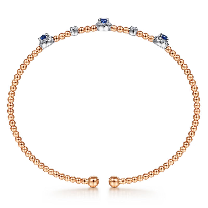 Front view of the rose gold Bujukan bangle with the sapphire centered in its diamond halo