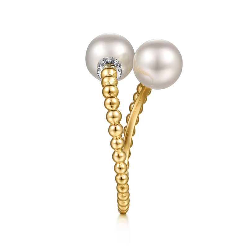 Side view of the Gabriel Bujukan pearl bypass ring showing the white gold diamond collar under each pearl