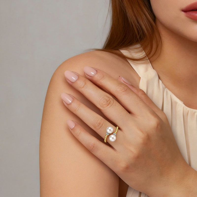 Gabriel & Co. Bujukan double pearl diamond collar bypass ring worn on a model's hand