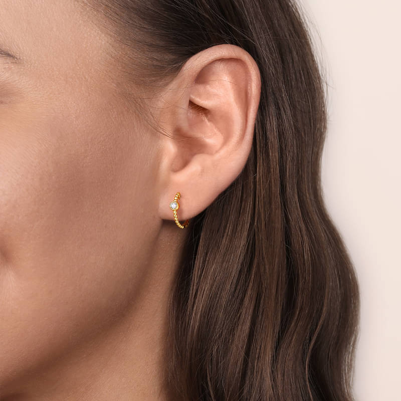 Gabriel & Co. 14K Yellow Gold Diamond Bujukan Huggie Earrings on Ear