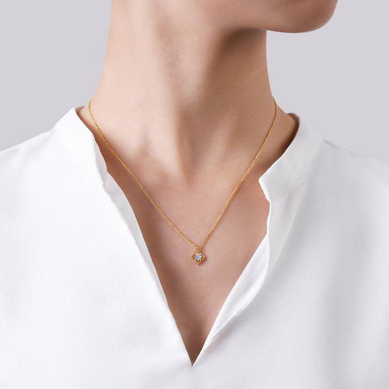 Gabriel & Co. NK6868 two-tone flower diamond pendant shown worn on a model with a white blouse