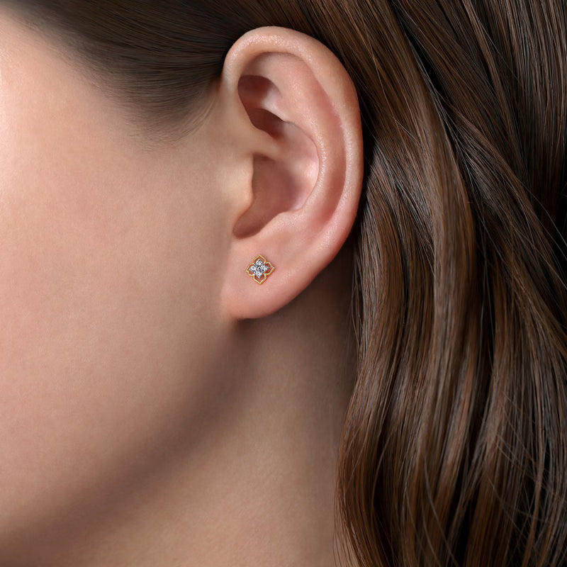 Gabriel & Co. EG14414 two-tone flower diamond stud earring shown worn on a model's ear