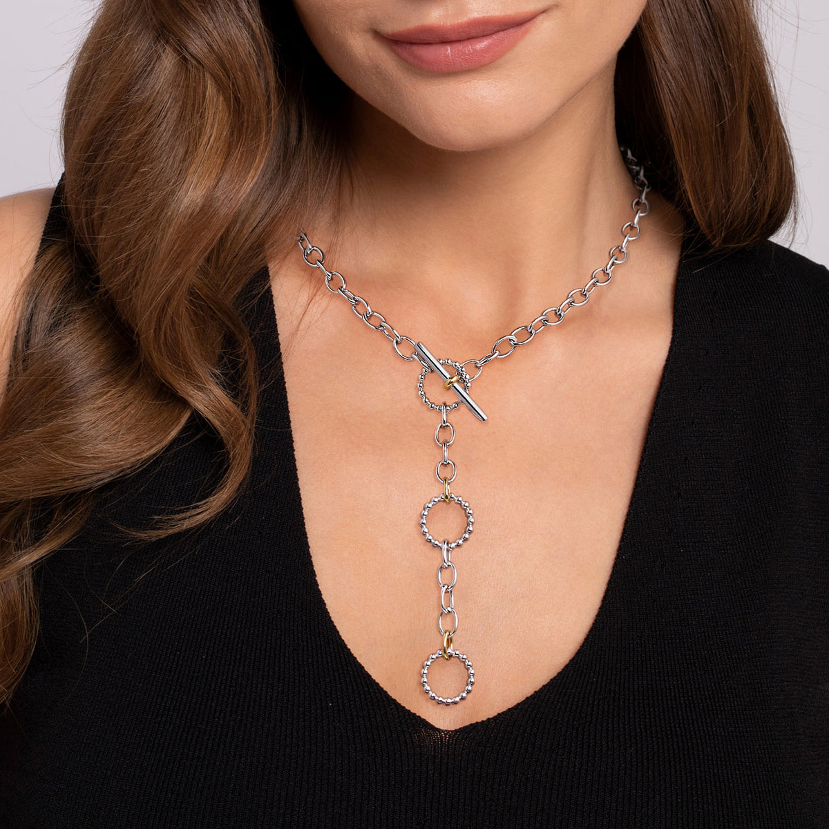 Model wearing the Gabriel & Co. two-tone Bujukan beaded circle Y-drop link necklace in sterling silver and 14K yellow gold
