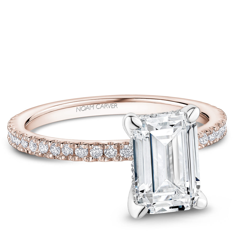 Noam Carver Rose & White Gold Prong Set Hidden Halo Emerald Cut Diamond Engagement Ring Featuring 0.30 Carats Total Weight Round Cut Shared Prong Set Diamonds.