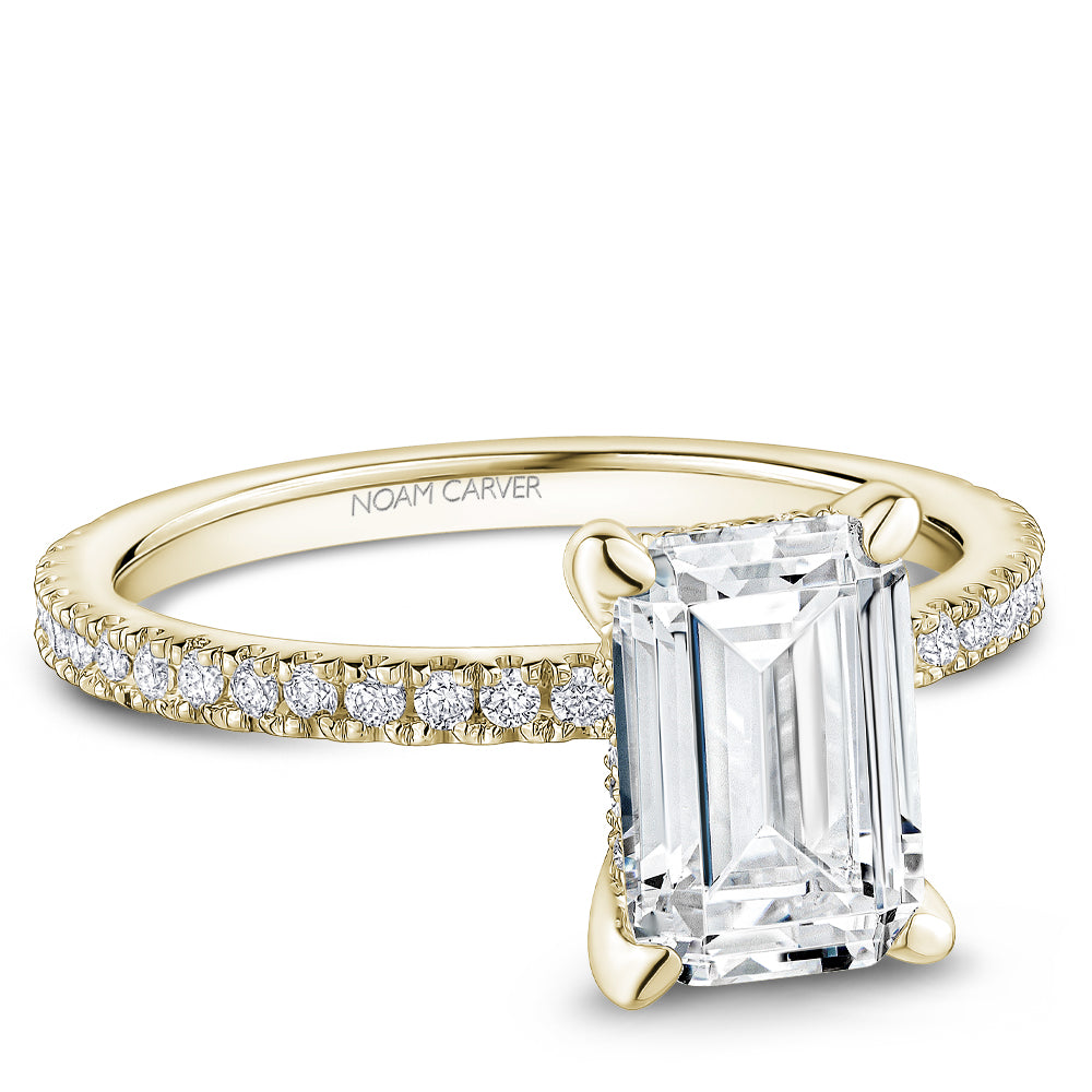 Noam Carver Yellow Gold Prong Set Hidden Halo Emerald Cut Diamond Engagement Ring Featuring 0.30 Carats Total Weight Round Cut Shared Prong Set Diamonds.