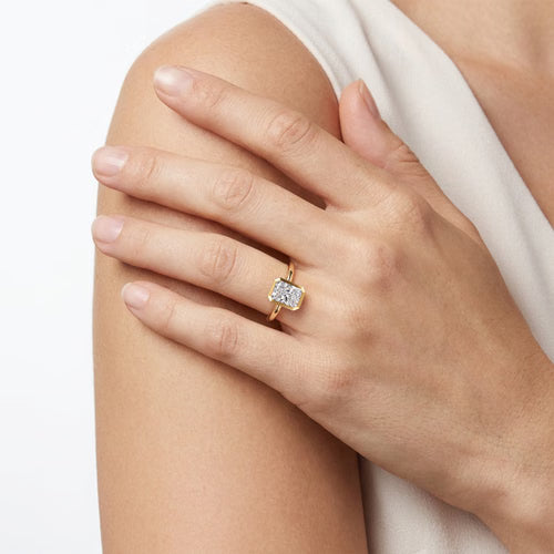 Gabriel & Co. Linny bezel-set radiant cut solitaire engagement ring in 14K yellow gold at Ben Garelick Jewelers On Hand