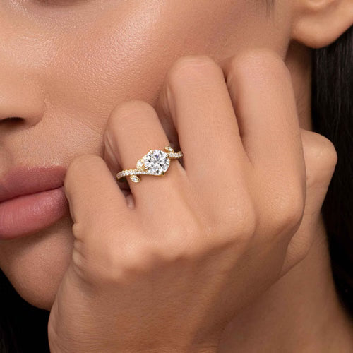 Gabriel & Co. Darcie Floral Nouveau leaf bypass engagement ring in 14K yellow gold with 0.25 ct of diamonds at Ben Garelick Jewelers On Hand