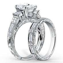 Load image into Gallery viewer, Kirk Kara White Gold &quot;Charlotte&quot; Emerald Cut Three Stone Diamond Engagement Ring Set Angled Side View
