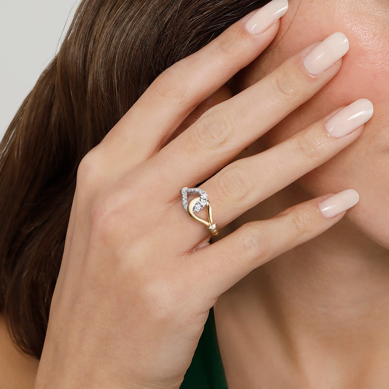 Gabriel & Co. LR53001 two-tone stirrup diamond ring worn on a model's hand