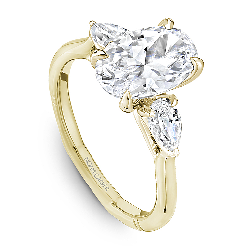 Angled view of the Noam Carver Atelier A092-02 three stone ring in yellow gold, pear side diamonds on a soft square Euro shank
