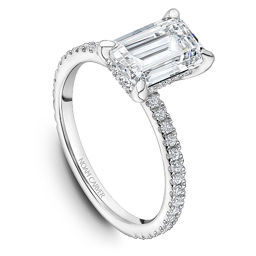 Noam Carver White Gold Prong Set Hidden Halo Emerald Cut Diamond Engagement Ring Featuring 0.30 Carats Total Weight Round Cut Shared Prong Set Diamonds.