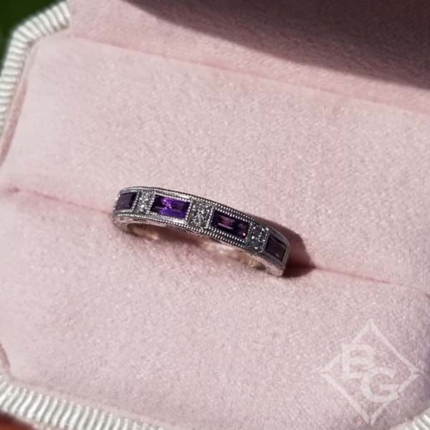 Kirk Kara White Gold "Charlotte" Baguette Cut Purple Amethyst Diamond Wedding Band Angled Top View In Box