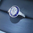 Load and play video in Gallery viewer, Video of Simon G. Oval Cut Blue Sapphire Baguette Halo Diamond Engagement Ring
