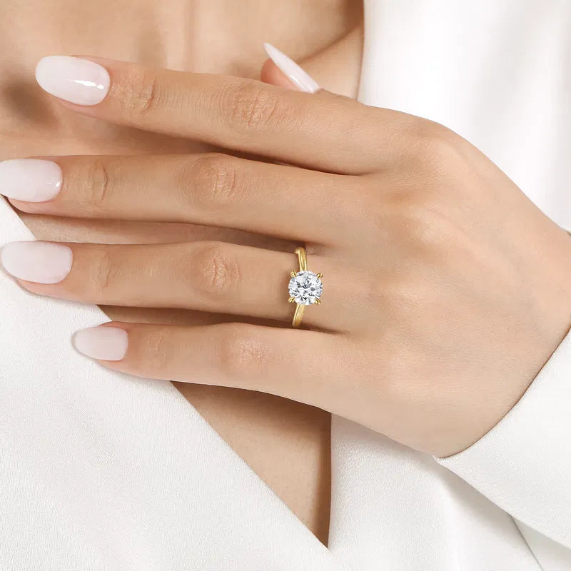 Gabriel & Co. Bena Yellow Gold Cathedral Round Solitaire Diamond Engagement Ring on hand