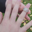 Load and play video in Gallery viewer, Video of  Simon G. Filigree Flower Tapered Diamond Ring on Finger
