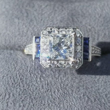 Load and play video in Gallery viewer, Video of Gabriel&#39;s Daisy Cushion Shaped Blue Sapphire Diamond Engagement Ring Gabriel &quot;Daisy&quot; Cushion Shaped Blue Sapphire Diamond Engagement Ring in Ring Box
