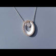 Load and play video in Gallery viewer, Simon G. Oval Shape White Enamel Contemporary Diamond Halo Pendant
