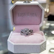 Load image into Gallery viewer, Kirk Kara White Gold &quot;Carmella&quot; Cushion Halo Baguette Station Blue Sapphire Diamond Engagement Ring Set On Box One on top of the other
