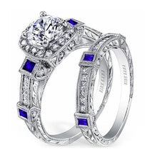 Load image into Gallery viewer, Kirk Kara White Gold &quot;Carmella&quot; Cushion Halo Baguette Station Blue Sapphire Diamond Engagement Ring Set Angled Side View
