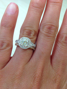Kirk Kara White Gold "Carmella" Round Cut Halo Diamond Engagement Ring Set On Model Hand Close up 