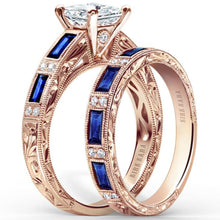 Load image into Gallery viewer, Kirk Kara Rose Gold &quot;Charlotte&quot; Blue Sapphire Baguette and Diamond Engagement Ring Set Angled Side View
