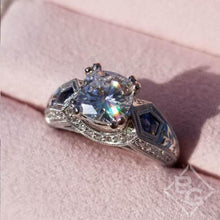 Load image into Gallery viewer, Kirk Kara White Gold &quot;Charlotte&quot; Kite Cut Blue Sapphire Diamond Engagement Ring Close Up Angled Side View In Box
