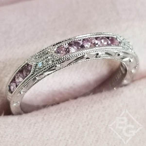Kirk Kara White Gold "Charlotte" Pink Sapphire Round Cut Diamond Wedding Band Angled Top View In Box