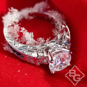 Kirk Kara White Gold "Charlotte" Three Stone Blue Sapphire Diamond Engagement Ring with snow on it 