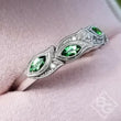 Load image into Gallery viewer, Kirk Kara Dahlia Green Tsavorite Garnet Leaf Diamond Wedding Band Close Up Angled Side View In Box
