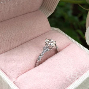 Kirk Kara White Gold "Lori" Oval Cut Diamond Engagement Ring Angled Side View In Box