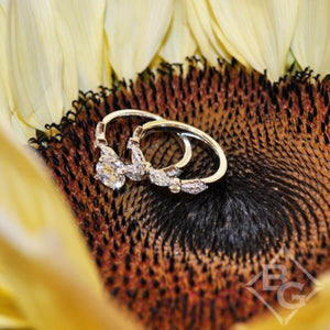 Kirk Kara White Gold "Lori" Vintage Style Twist Diamond Engagement Ring SetAngled Front View with Floral Background